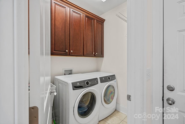 clothes washing area with cabinets, light tile patterned floors, and separate washer and dryer