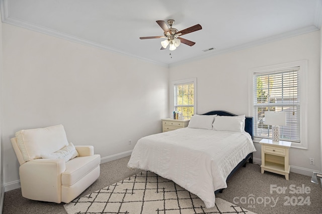 carpeted bedroom with ceiling fan and ornamental molding