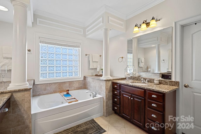 bathroom featuring decorative columns, vanity, crown molding, tile patterned flooring, and a bathing tub