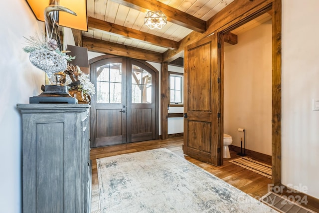 entryway with beam ceiling, wood-type flooring, and wooden ceiling