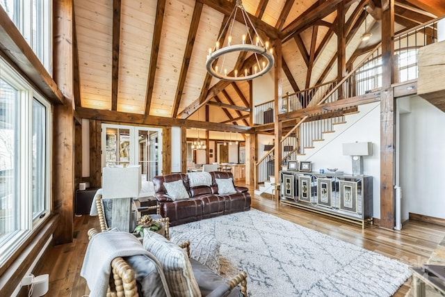 living room with beamed ceiling, hardwood / wood-style floors, and high vaulted ceiling