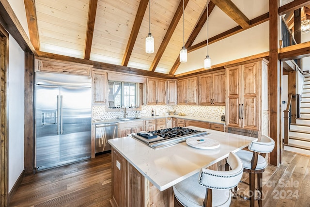 kitchen featuring sink, a center island, dark hardwood / wood-style floors, and appliances with stainless steel finishes