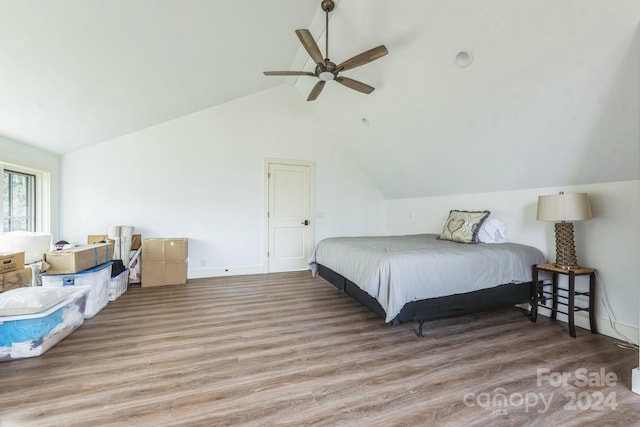 bedroom with light hardwood / wood-style flooring, ceiling fan, and lofted ceiling