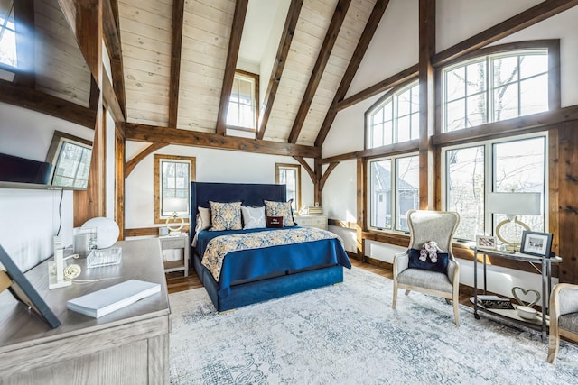 bedroom with beamed ceiling, hardwood / wood-style floors, high vaulted ceiling, and multiple windows