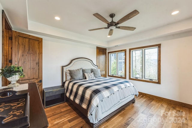 bedroom featuring ceiling fan and dark hardwood / wood-style flooring