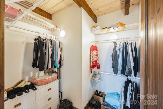 spacious closet with beamed ceiling