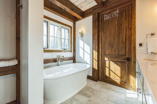 bathroom with vanity, beam ceiling, wood ceiling, and a bath