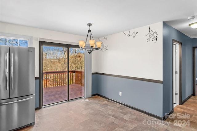 unfurnished dining area featuring a notable chandelier