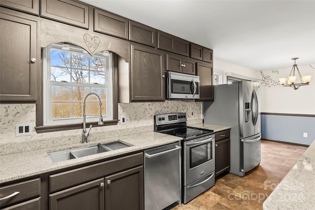 kitchen featuring dark brown cabinetry, sink, hanging light fixtures, stainless steel appliances, and an inviting chandelier