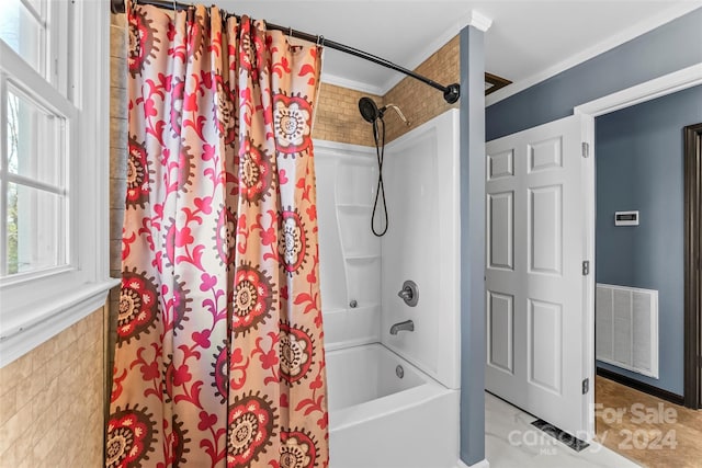 bathroom with shower / bathtub combination with curtain and crown molding