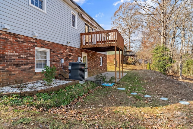 view of yard with cooling unit and a deck