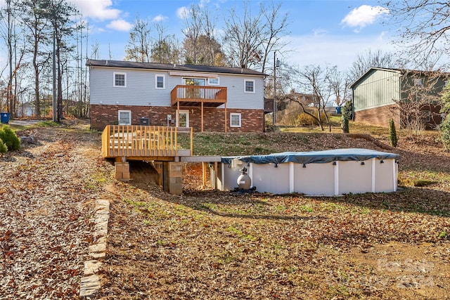 back of house featuring a balcony and a pool side deck