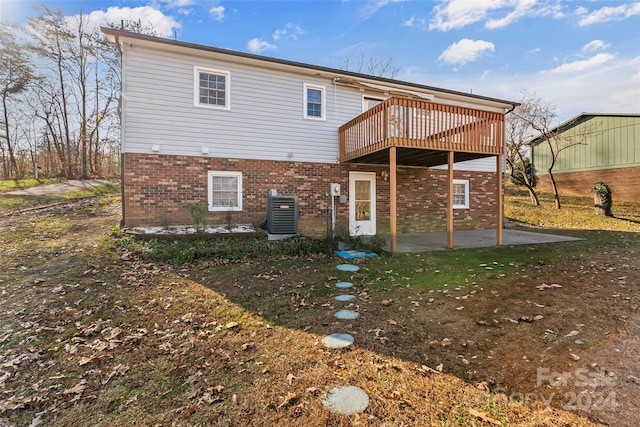 rear view of house featuring a deck, a patio area, and central air condition unit