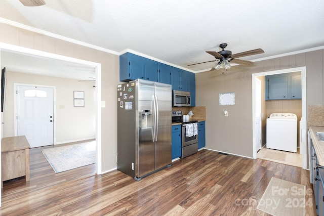 kitchen with ornamental molding, stainless steel appliances, blue cabinets, washer / dryer, and dark hardwood / wood-style floors