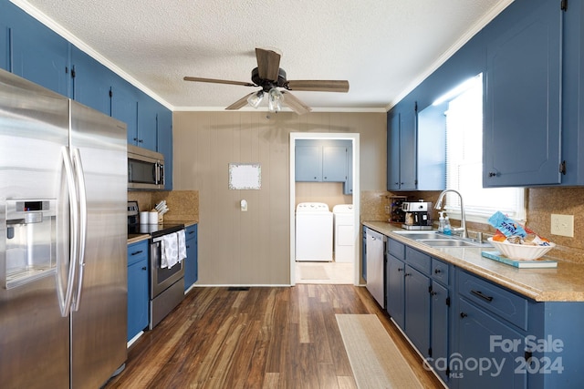 kitchen featuring sink, blue cabinets, stainless steel appliances, and dark wood-type flooring