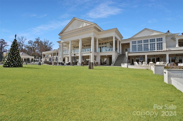 rear view of property with a lawn and a patio area