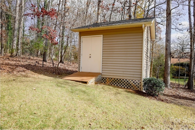 view of outbuilding featuring a lawn