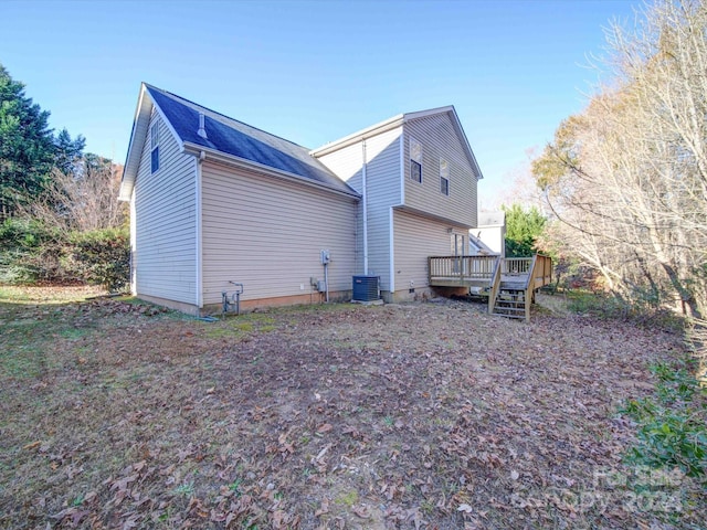 view of side of home with central air condition unit and a wooden deck