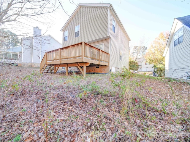 rear view of house featuring a wooden deck