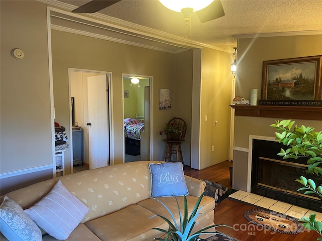 living room with a textured ceiling, hardwood / wood-style flooring, and crown molding