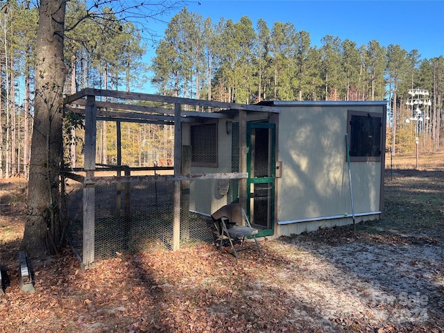 rear view of property with an outbuilding