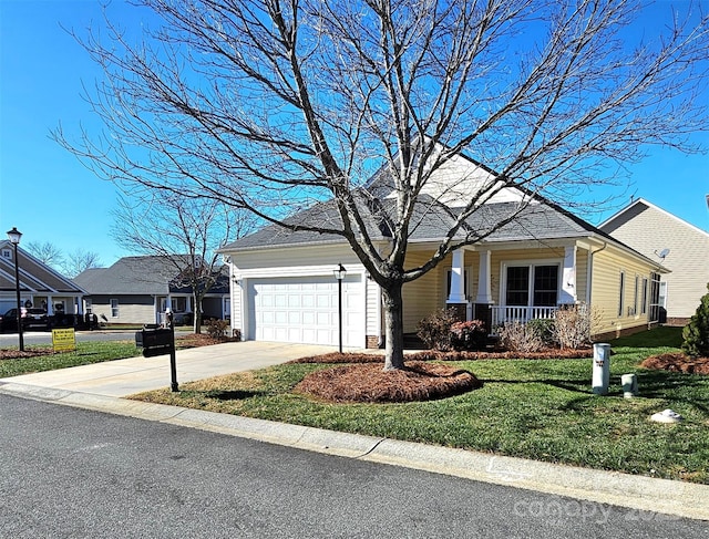 view of front facade with a front yard, a porch, and a garage