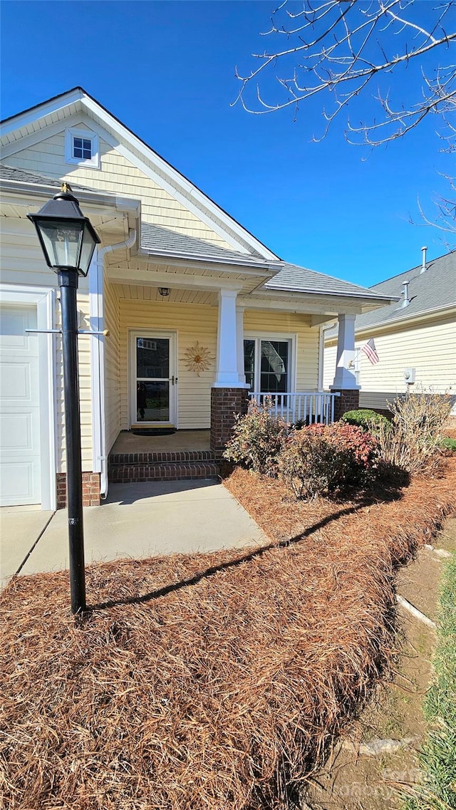 exterior space featuring covered porch and a garage