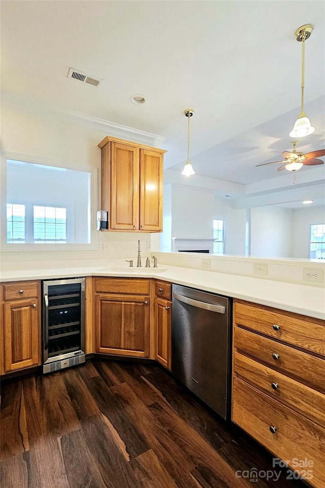 kitchen featuring a healthy amount of sunlight, decorative light fixtures, dark wood-type flooring, beverage cooler, and stainless steel dishwasher