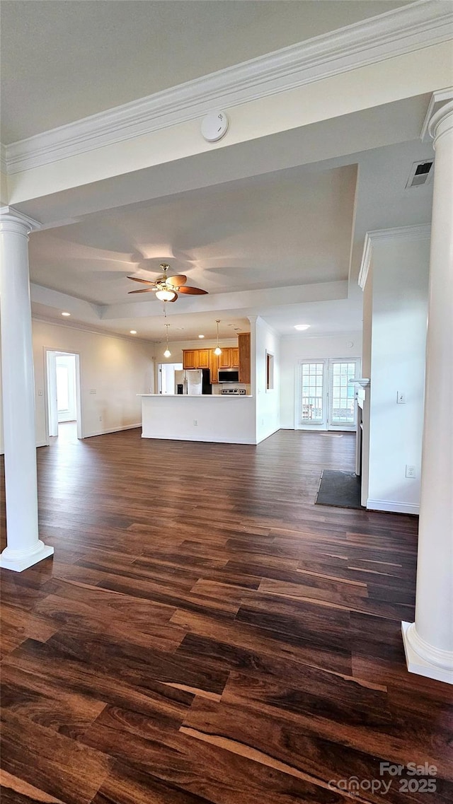 unfurnished living room featuring ceiling fan, dark hardwood / wood-style floors, a tray ceiling, and ornamental molding