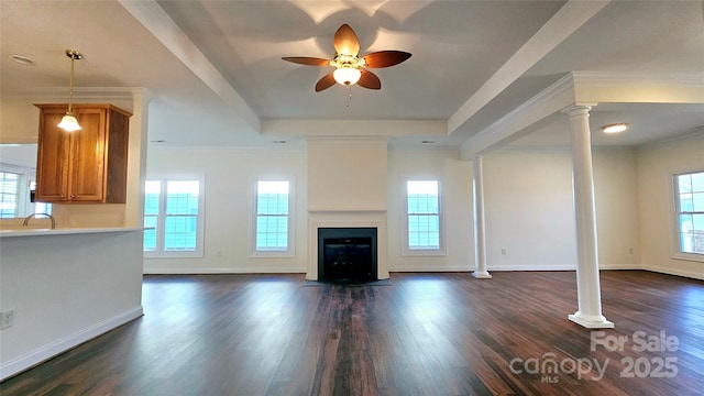 unfurnished living room with ceiling fan, dark wood-type flooring, a tray ceiling, and ornamental molding