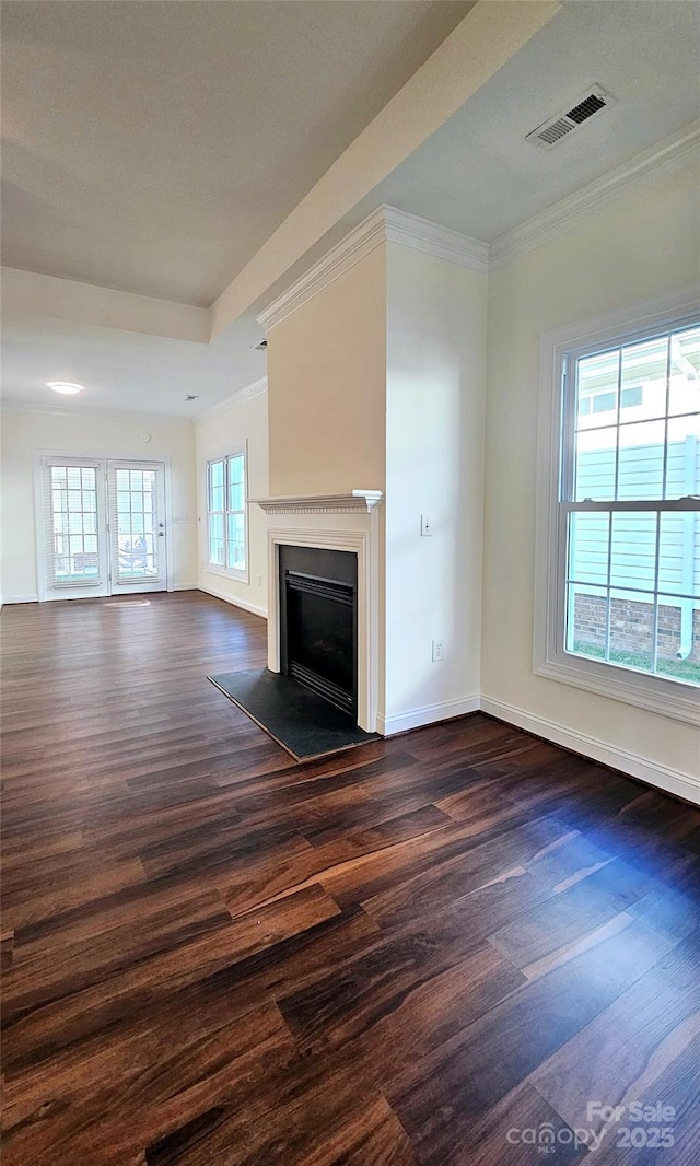 unfurnished living room featuring dark hardwood / wood-style floors and ornamental molding