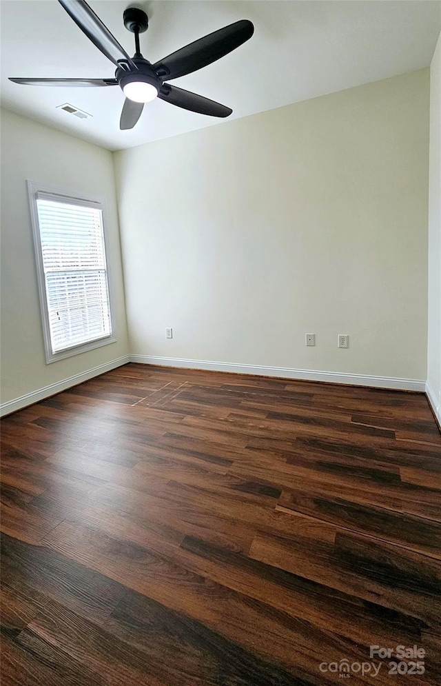 unfurnished room with dark wood-type flooring and ceiling fan