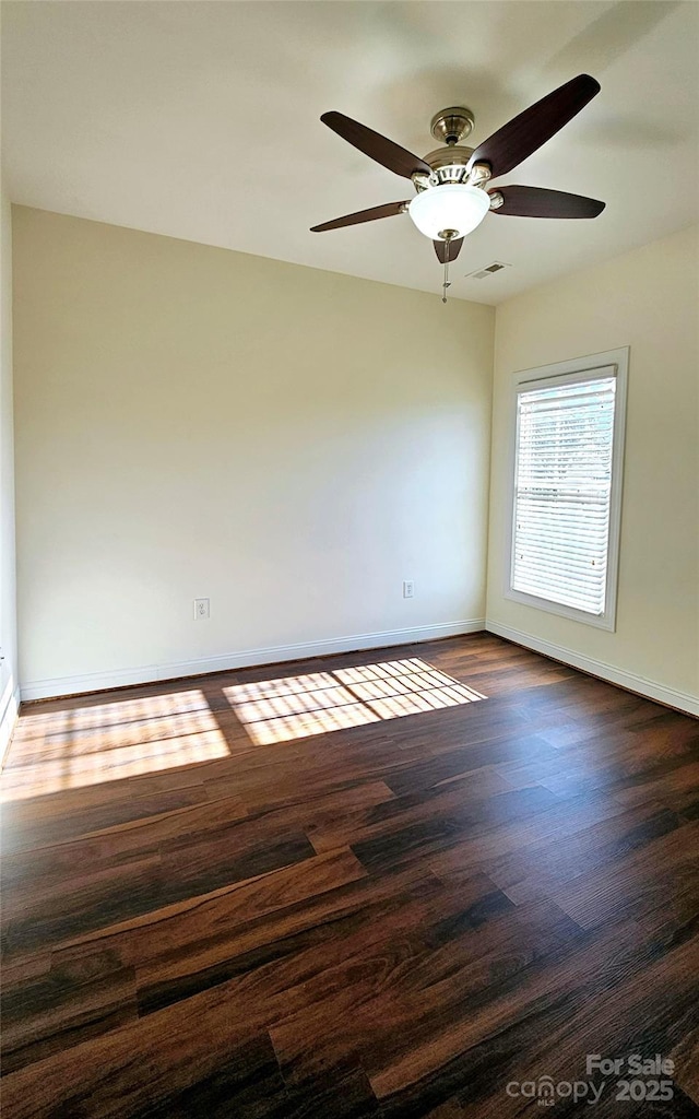 spare room with ceiling fan and dark wood-type flooring