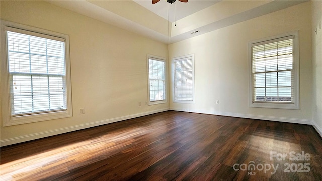 empty room featuring ceiling fan and dark hardwood / wood-style floors