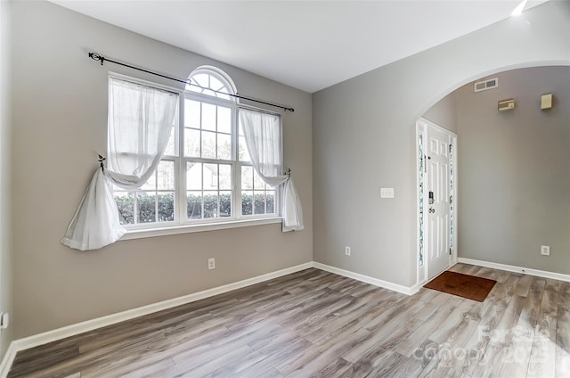 unfurnished room with light hardwood / wood-style flooring