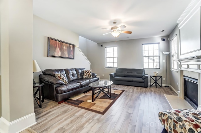 living room with ceiling fan and light wood-type flooring