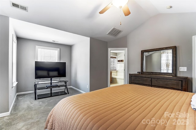 bedroom featuring ceiling fan, ensuite bath, light carpet, and vaulted ceiling