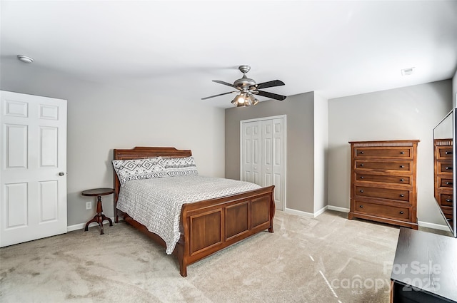 bedroom featuring ceiling fan, a closet, and light carpet