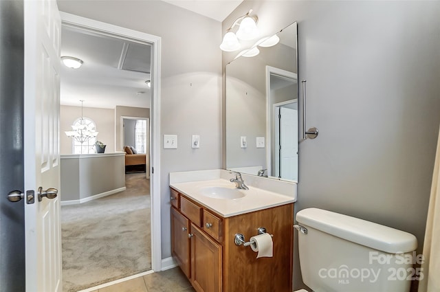 bathroom with toilet, tile patterned floors, and vanity