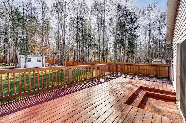 deck with a yard and an outdoor structure