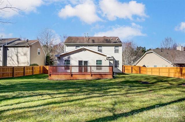 rear view of property featuring a lawn and a wooden deck