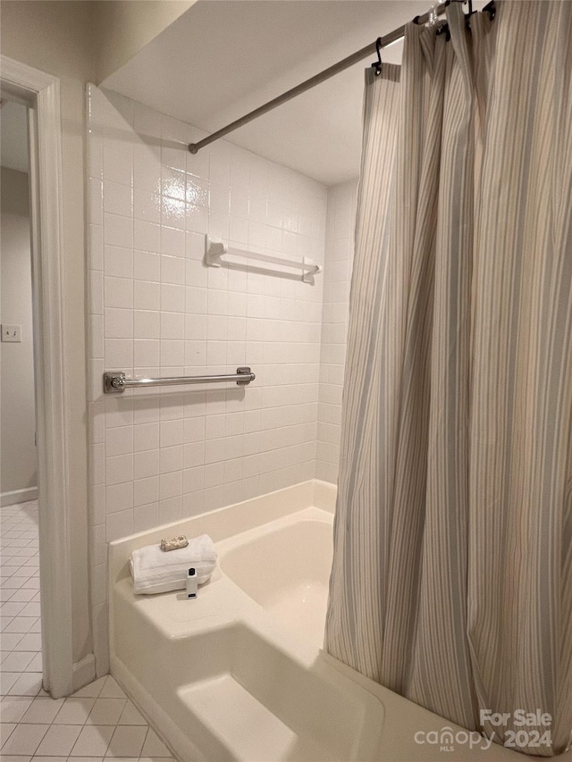 bathroom with tile patterned flooring and shower / bathtub combination with curtain