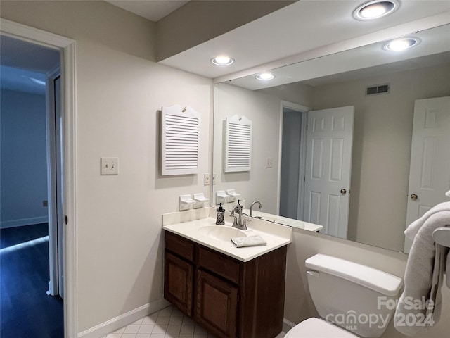 bathroom featuring vanity and toilet