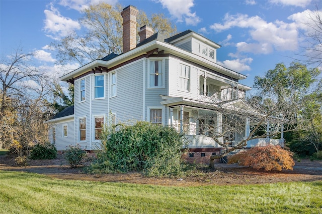 view of side of property with a yard