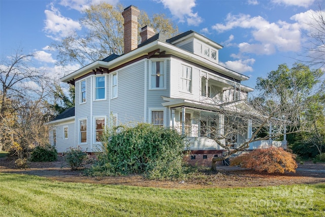 318 N Elm St, Marshville, NC 28103 - view of side of property with a chimney, a balcony, and a yard