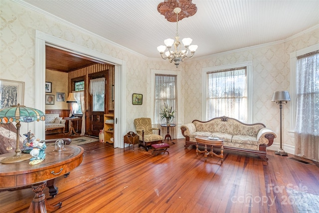 318 N Elm St, Marshville, NC 28103 - living room with wood-type flooring, a chandelier, wallpapered walls, healthy amount of natural light, and ornamental molding