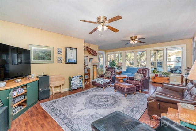 living room featuring ceiling fan and wood-type flooring