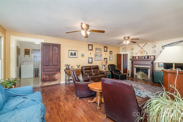 318 N Elm St, Marshville, NC 28103 - living room featuring washer / dryer, ceiling fan, a fireplace, and wood finished floors