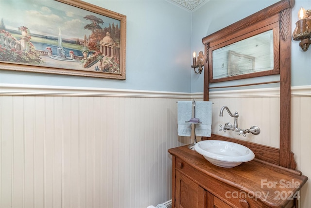 bathroom featuring vanity and ornamental molding