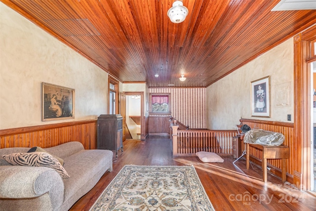 bedroom featuring dark hardwood / wood-style flooring, crown molding, wood walls, and wood ceiling